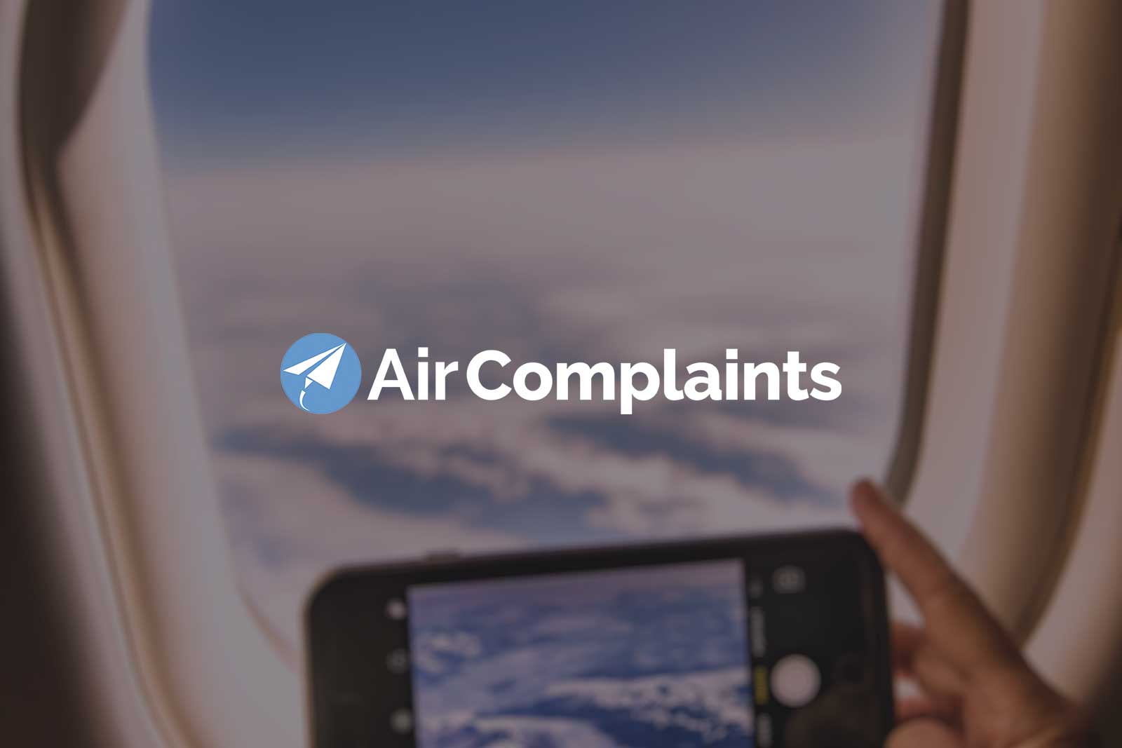 Air Complaints logo placed over blurred image of sky seen through airplane window,